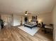 Spacious bedroom with wood floors, ceiling fan, walk-in closet, and adjacent desk space at 4524 W Larkspur Dr, Glendale, AZ 85304