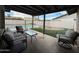 Covered patio with ample seating, with a beautiful view of pool and backyard at 4524 W Larkspur Dr, Glendale, AZ 85304