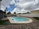Backyard pool and patio, surrounded by decorative landscaping at 4524 W Larkspur Dr, Glendale, AZ 85304