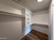 Bright, clean walk-in closet with built-in shelving and hanging rods at 4524 W Larkspur Dr, Glendale, AZ 85304