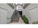Exterior entrance to the property features stairs leading to an upper unit, dual doors and lush greenery at 4533 N 22Nd St # 228, Phoenix, AZ 85016