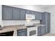 Clean kitchen with gray cabinets, white appliances, and granite countertops at 4533 N 22Nd St # 228, Phoenix, AZ 85016