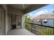 Private balcony with black metal railing offers views of surrounding greenery and neighboring residences at 4533 N 22Nd St # 228, Phoenix, AZ 85016