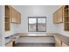 Bright office space with built-in desk, storage cabinets and a large window at 4533 N 22Nd St # 228, Phoenix, AZ 85016