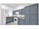 A well-maintained kitchen features stylish blue cabinets and modern appliances at 4533 N 22Nd St # 228, Phoenix, AZ 85016