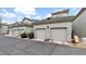 Row of townhouse-style condos feature two-car garages, beige stucco exteriors, and well-manicured landscaping at 4533 N 22Nd St # 228, Phoenix, AZ 85016