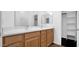 Bathroom with double sinks, wooden cabinetry, and tile flooring at 4533 N 22Nd St # 228, Phoenix, AZ 85016