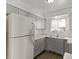Kitchen with gray cabinets and a new refrigerator at 4714 E Belleview St, Phoenix, AZ 85008