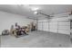 Garage includes a fan, exercise bike, shelving, and roll up door at 4817 E Thunderbird Dr, Chandler, AZ 85249