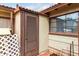 Exterior of the home featuring a storage area with a window, door, and brick and siding details at 4837 E Avalon Dr, Phoenix, AZ 85018