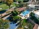Aerial view of a luxury home featuring a pool, tennis court, and meticulously landscaped grounds at 4900 E Desert Fairways Dr, Paradise Valley, AZ 85253