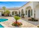 Expansive backyard featuring a pristine pool, elegant arches, and meticulously manicured landscaping and hardscape at 4900 E Desert Fairways Dr, Paradise Valley, AZ 85253