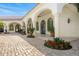 Stunning backyard patio with arched walkways, lush greenery, and manicured landscaping, creating a serene outdoor space at 4900 E Desert Fairways Dr, Paradise Valley, AZ 85253
