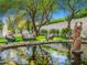 Tranquil backyard pond with lush landscaping and cozy seating areas, creating a serene outdoor retreat at 4900 E Desert Fairways Dr, Paradise Valley, AZ 85253