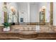 This luxurious bathroom features a unique stone sink, decorative plants, and modern lighting at 4900 E Desert Fairways Dr, Paradise Valley, AZ 85253