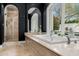 Elegant bathroom with a large soaking tub, glass enclosed shower, and plenty of natural light at 4900 E Desert Fairways Dr, Paradise Valley, AZ 85253