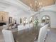 Formal dining room with a long table, chandelier, and access to the living room creating an elegant space for gatherings at 4900 E Desert Fairways Dr, Paradise Valley, AZ 85253
