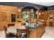 Well-appointed kitchen with custom cabinets, granite counters, a central island, and pendant lighting, perfect for entertaining at 4900 E Desert Fairways Dr, Paradise Valley, AZ 85253