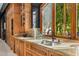 Gourmet kitchen featuring custom wood cabinetry, granite countertops, and a large window with views of the surrounding nature at 4900 E Desert Fairways Dr, Paradise Valley, AZ 85253