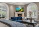 Cozy living room with a fireplace, plush seating, and arched windows with shutters at 4900 E Desert Fairways Dr, Paradise Valley, AZ 85253