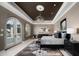 This spacious main bedroom features a decorative rug, chandelier, and direct access to a private outdoor area at 4900 E Desert Fairways Dr, Paradise Valley, AZ 85253