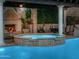 Inviting pool and spa area with a fireplace and a covered patio perfect for entertaining and relaxing at 4900 E Desert Fairways Dr, Paradise Valley, AZ 85253
