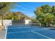 Private tennis court with mountain views, set amidst lush greenery, offering a perfect spot for recreation at 4900 E Desert Fairways Dr, Paradise Valley, AZ 85253
