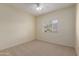 Cozy bedroom with neutral carpet, ceiling fan, and sunny window with bright natural light at 525 N Miller Rd # 220, Scottsdale, AZ 85257