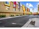 Modern townhome complex with vibrant accents, garages, and manicured landscaping on a sunny day at 541 E Ames Pl, Phoenix, AZ 85004