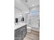 Bright bathroom with a combination shower and tub and a gray vanity at 5611 S Feliz --, Mesa, AZ 85212