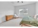 Bright bedroom featuring a rocking chair, light wood dresser, neutral carpet, and a ceiling fan at 5611 S Feliz --, Mesa, AZ 85212