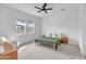 Bright primary bedroom featuring a ceiling fan, two windows, neutral carpet, and an accent chair at 5611 S Feliz --, Mesa, AZ 85212