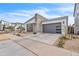 Attractive home featuring a modern design, stone accents, and a well-kept front yard at 5611 S Feliz --, Mesa, AZ 85212