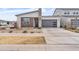 Contemporary home exterior with stone accents, well-manicured landscaping, and a two-car garage at 5611 S Feliz --, Mesa, AZ 85212