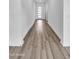 Bright hallway features wood-look flooring and a modern front door with glass panels at 5611 S Feliz --, Mesa, AZ 85212