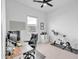 Modern office space with large windows, a ceiling fan, and a home exercise bike at 5611 S Feliz --, Mesa, AZ 85212