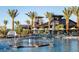 Resort-style pool with palm trees, lounge chairs, and water features creates a relaxing outdoor oasis at 5611 S Feliz --, Mesa, AZ 85212