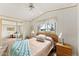 Bright bedroom with a cozy bed, bedside tables, and a view to the outside at 5735 E Mcdowell Rd # 147, Mesa, AZ 85215