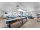 Well-lit game room featuring shuffleboard, pool tables, ping pong, and viewing windows at 5735 E Mcdowell Rd # 147, Mesa, AZ 85215