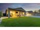 Inviting backyard featuring an extended covered patio with outdoor seating and a large, well-maintained lawn at 6404 W Black Hill Rd, Phoenix, AZ 85083