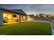 Serene backyard featuring an extended covered patio, lush lawn, and peaceful privacy at 6404 W Black Hill Rd, Phoenix, AZ 85083