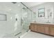 Modern bathroom featuring a large glass shower and double vanity at 6404 W Black Hill Rd, Phoenix, AZ 85083