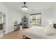 Bright bedroom boasts hardwood floors, large windows, modern desk and shelving at 6404 W Black Hill Rd, Phoenix, AZ 85083