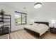 Bright bedroom boasts hardwood floors and a view of the manicured yard at 6404 W Black Hill Rd, Phoenix, AZ 85083