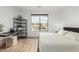 Bright bedroom boasts hardwood floors, large windows, modern desk and shelving at 6404 W Black Hill Rd, Phoenix, AZ 85083