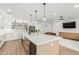 Bright open-concept kitchen with large island, white cabinets, and stainless steel appliances at 6404 W Black Hill Rd, Phoenix, AZ 85083