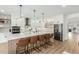 Bright open-concept kitchen with large island, white cabinets, and stainless steel appliances at 6404 W Black Hill Rd, Phoenix, AZ 85083