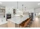 Bright open-concept kitchen with large island, white cabinets, and stainless steel appliances at 6404 W Black Hill Rd, Phoenix, AZ 85083