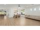 Open-concept living area with neutral decor, wood floors, a dining table and modern lighting at 6404 W Black Hill Rd, Phoenix, AZ 85083