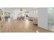 Spacious and well-lit living area featuring wood floors, modern lighting, and a sleek layout at 6404 W Black Hill Rd, Phoenix, AZ 85083